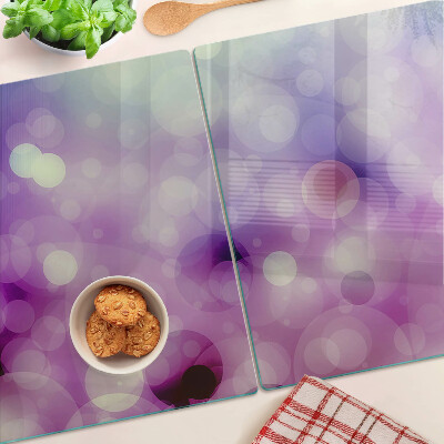 Tagliere in vetro con motivo bokeh nei toni del viola e del rosa