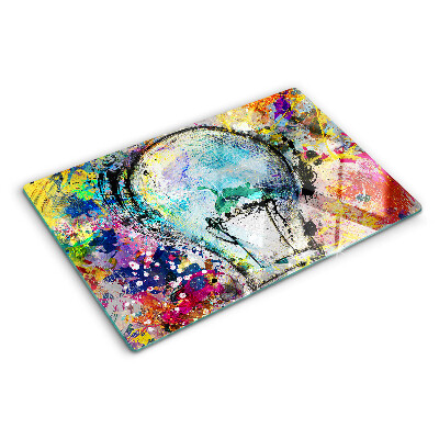 Tagliere in vetro temperato con stampa di una lampadina su sfondo colorato