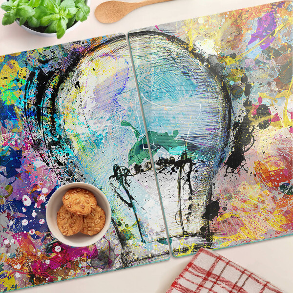 Tagliere in vetro temperato con stampa di una lampadina su sfondo colorato