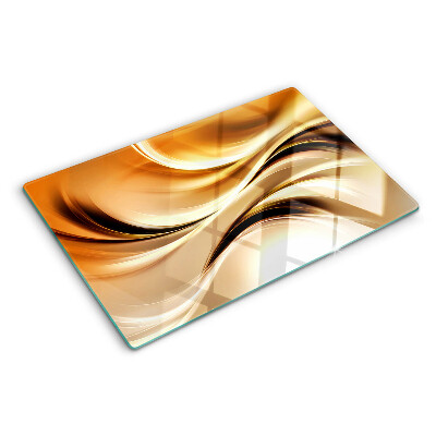 Tagliere in vetro con decorazione a onde astratte nei toni dell'oro