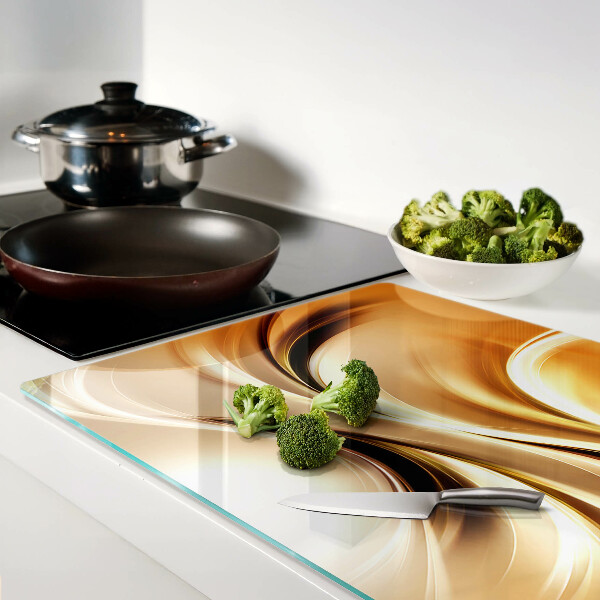 Tagliere in vetro con decorazione a onde astratte nei toni dell'oro