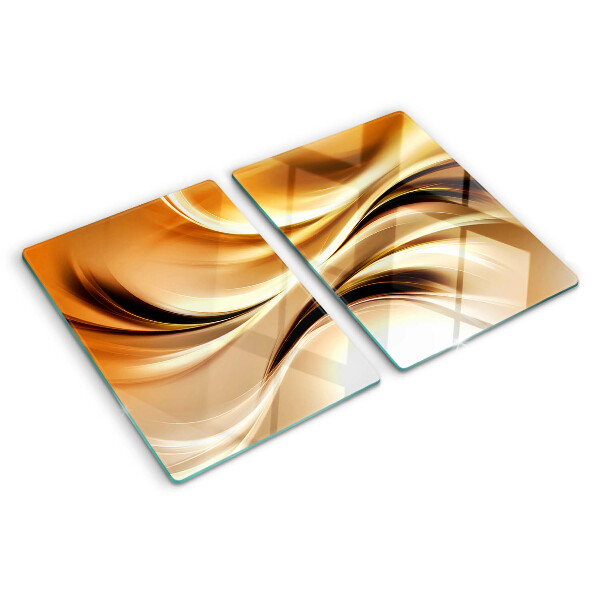 Tagliere in vetro con decorazione a onde astratte nei toni dell'oro