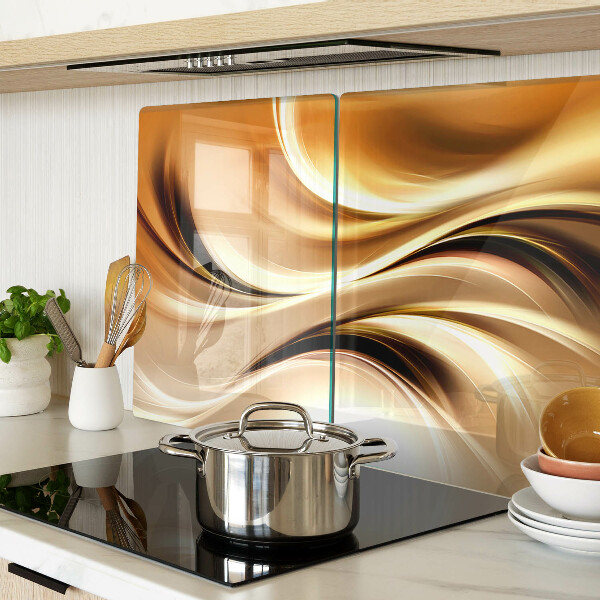 Tagliere in vetro con decorazione a onde astratte nei toni dell'oro