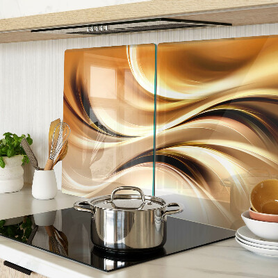 Tagliere in vetro con decorazione a onde astratte nei toni dell'oro