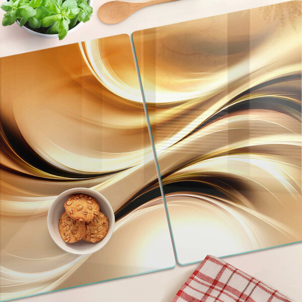 Tagliere in vetro con decorazione a onde astratte nei toni dell'oro
