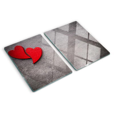 Tagliere in vetro temperato con motivo a cuore sullo sfondo di una finestra