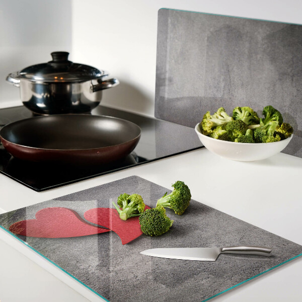 Tagliere in vetro temperato con motivo a cuore sullo sfondo di una finestra