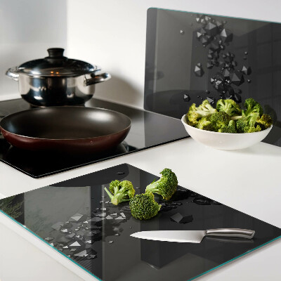 Tagliere in vetro con motivo a cristalli neri sullo sfondo