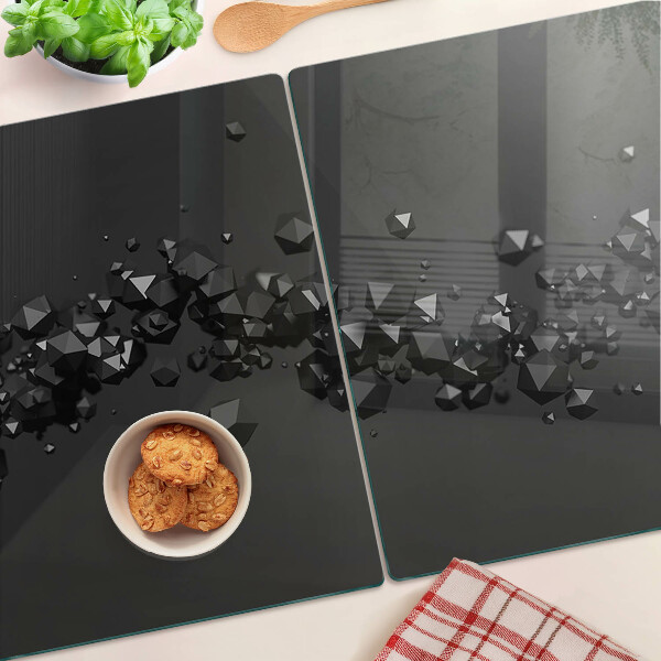 Tagliere in vetro con motivo a cristalli neri sullo sfondo