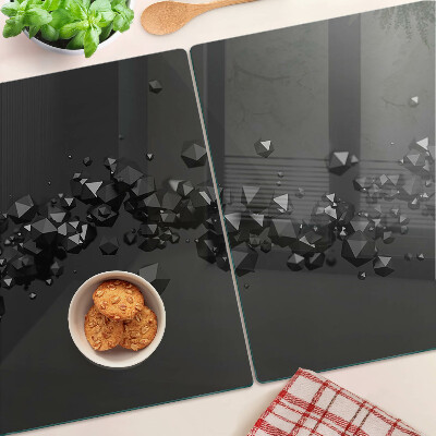 Tagliere in vetro con motivo a cristalli neri sullo sfondo