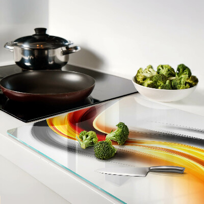 Tagliere in vetro temperato con motivo a onde nei toni dell'arancione e del nero