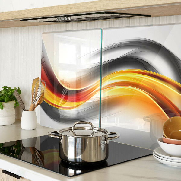 Tagliere in vetro temperato con motivo a onde nei toni dell'arancione e del nero