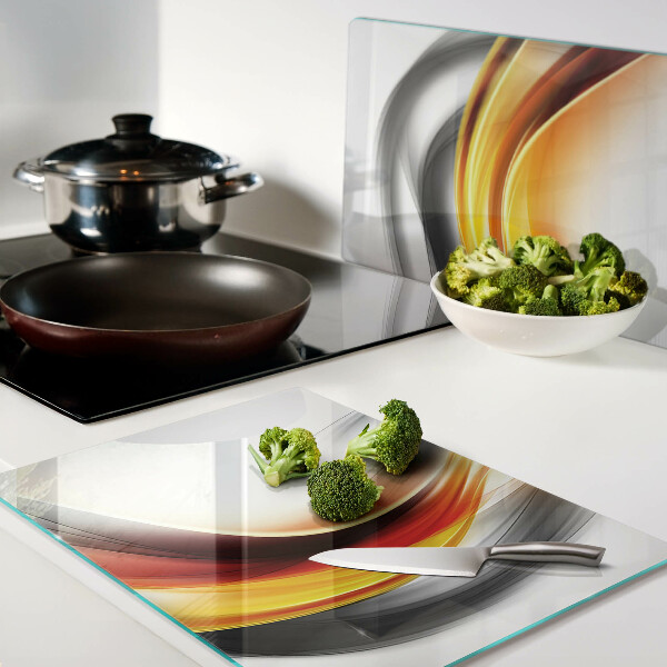 Tagliere in vetro temperato con motivo a onde nei toni dell'arancione e del nero