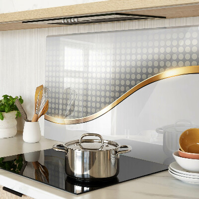 Tagliere in vetro temperato con motivo a onda dorata su sfondo a pois