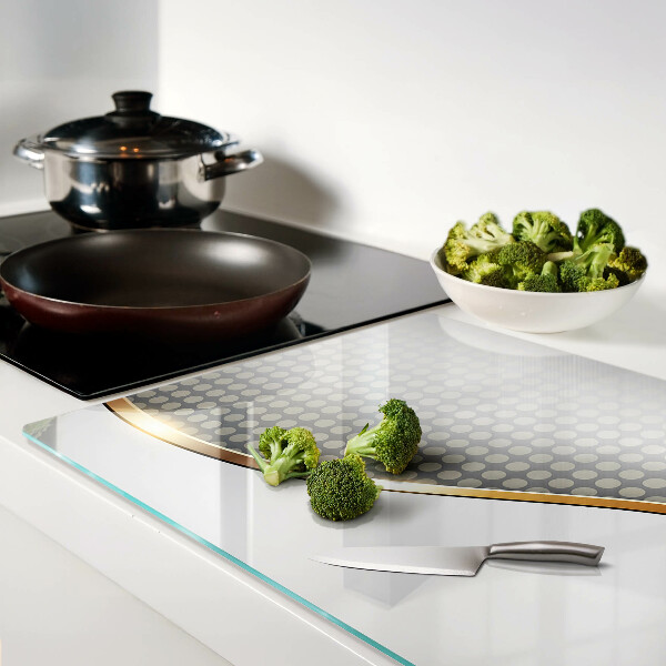 Tagliere in vetro temperato con motivo a onda dorata su sfondo a pois