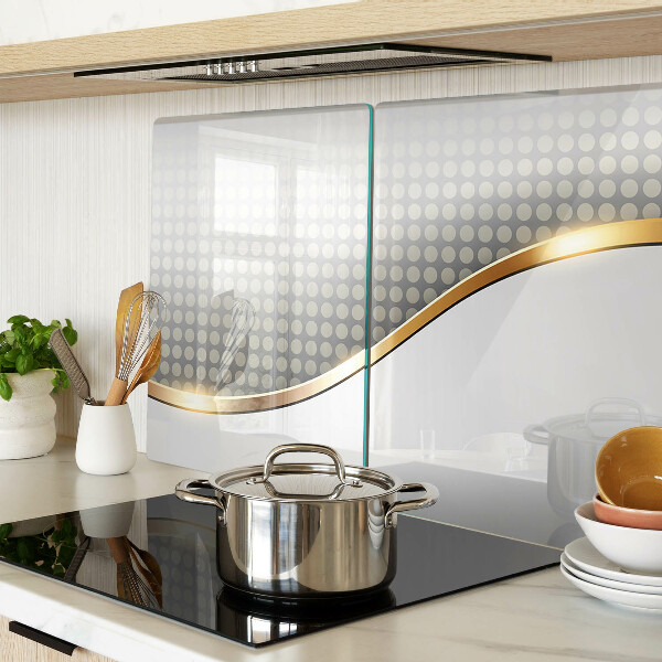 Tagliere in vetro temperato con motivo a onda dorata su sfondo a pois