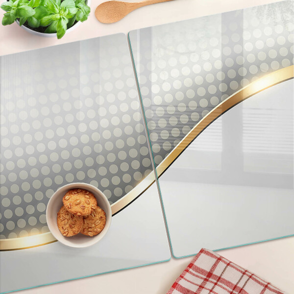 Tagliere in vetro temperato con motivo a onda dorata su sfondo a pois