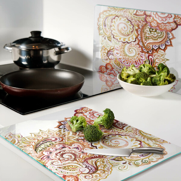 Tagliere in vetro con motivo paisley nei toni del rosso e dell'oro