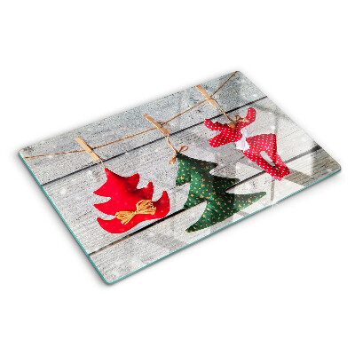 Tagliere in vetro temperato con decorazioni natalizie su sfondo di legno