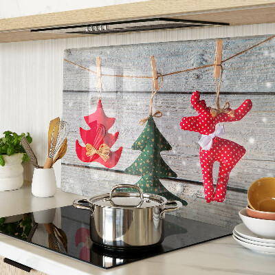 Tagliere in vetro temperato con decorazioni natalizie su sfondo di legno