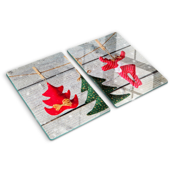 Tagliere in vetro temperato con decorazioni natalizie su sfondo di legno