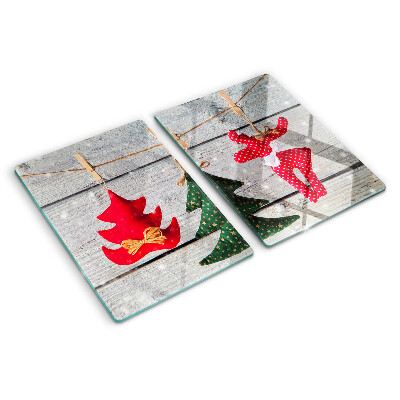 Tagliere in vetro temperato con decorazioni natalizie su sfondo di legno