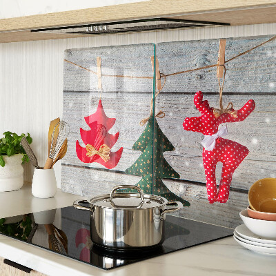 Tagliere in vetro temperato con decorazioni natalizie su sfondo di legno