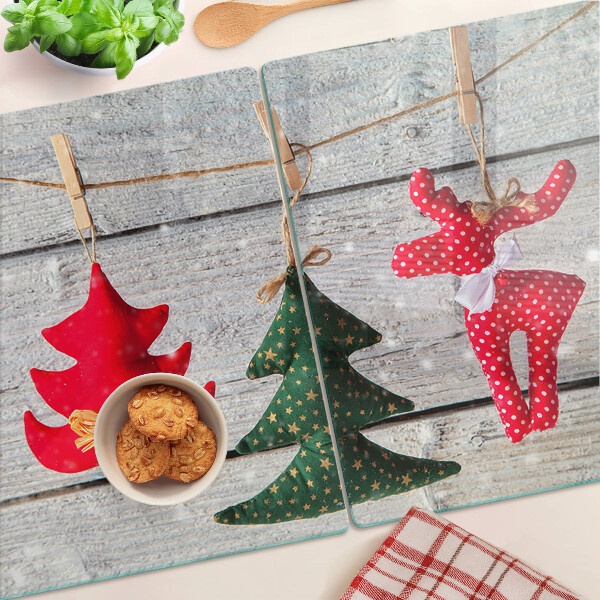 Tagliere in vetro temperato con decorazioni natalizie su sfondo di legno