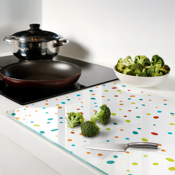 Tagliere in vetro temperato con punti colorati su sfondo bianco