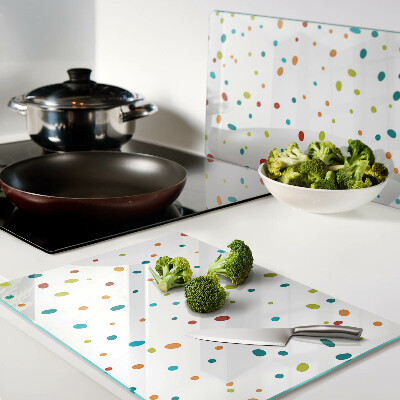 Tagliere in vetro temperato con punti colorati su sfondo bianco