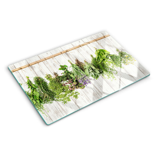 Tagliere in vetro temperato con decorazione di erbe su sfondo di legno