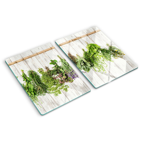 Tagliere in vetro temperato con decorazione di erbe su sfondo di legno