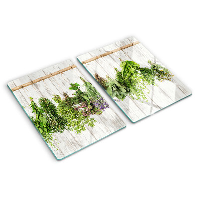 Tagliere in vetro temperato con decorazione di erbe su sfondo di legno