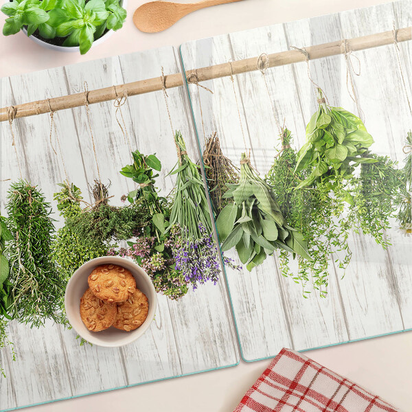 Tagliere in vetro temperato con decorazione di erbe su sfondo di legno