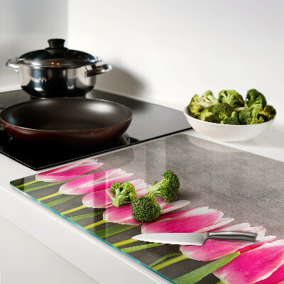 Tagliere in vetro con decorazione di tulipani su sfondo grigio