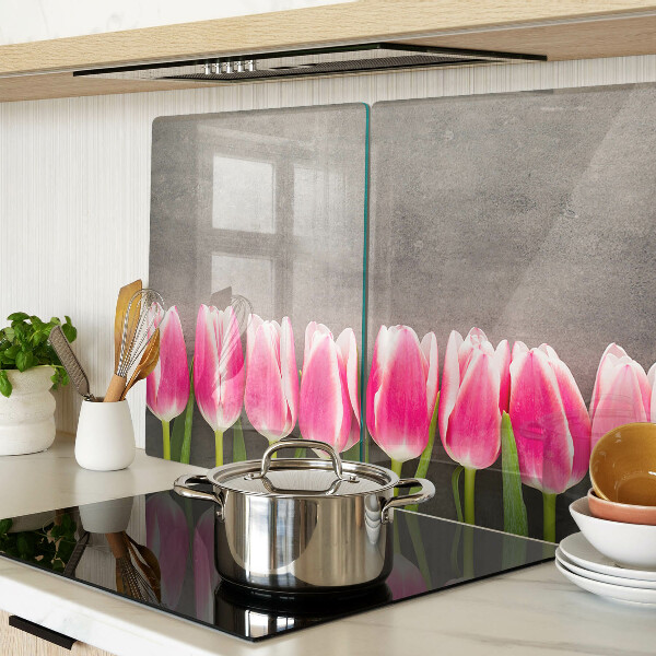 Tagliere in vetro con decorazione di tulipani su sfondo grigio