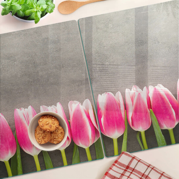 Tagliere in vetro con decorazione di tulipani su sfondo grigio