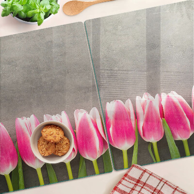 Tagliere in vetro con decorazione di tulipani su sfondo grigio