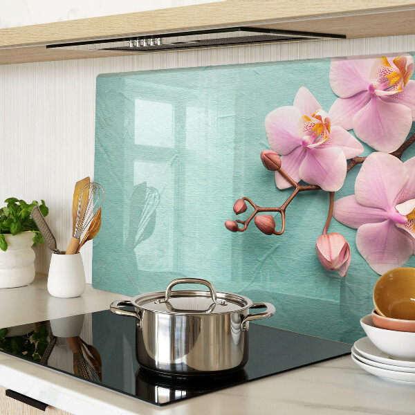 Tagliere in vetro con stampa di orchidee su sfondo blu