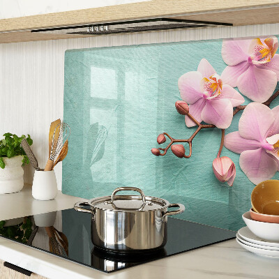 Tagliere in vetro con stampa di orchidee su sfondo blu