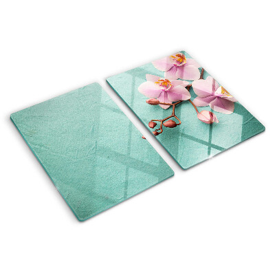 Tagliere in vetro con stampa di orchidee su sfondo blu