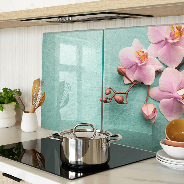 Tagliere in vetro con stampa di orchidee su sfondo blu