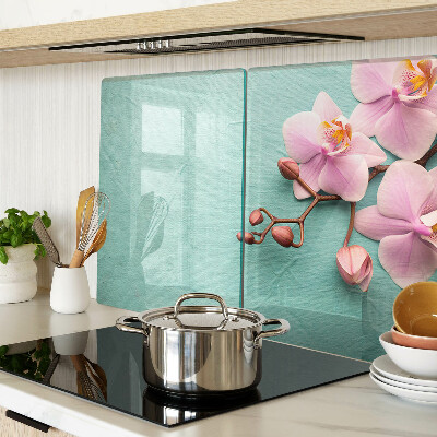 Tagliere in vetro con stampa di orchidee su sfondo blu