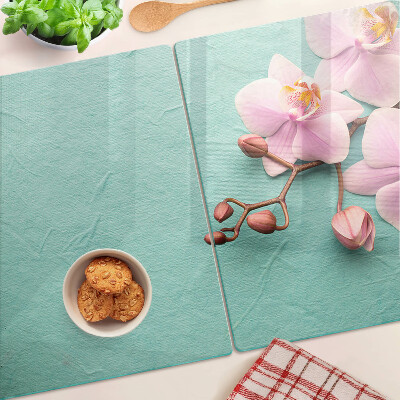 Tagliere in vetro con stampa di orchidee su sfondo blu