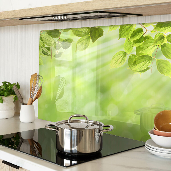 Tagliere in vetro con motivo di foglie verdi su sfondo chiaro