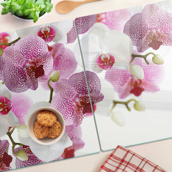 Tagliere in vetro con motivo di orchidee davanti alla finestra