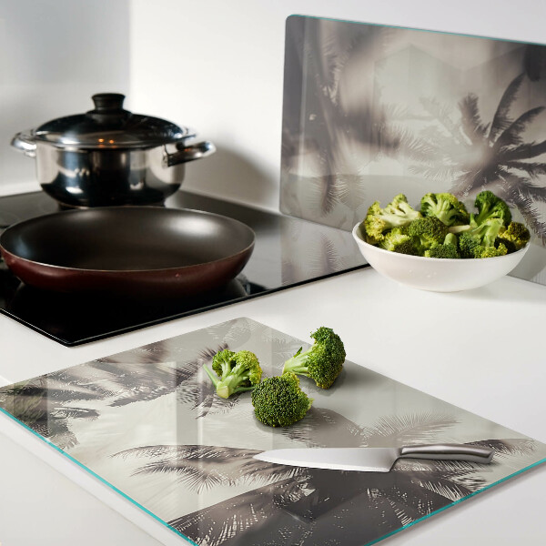 Tagliere in vetro temperato con motivo di palme su sfondo monocromatico