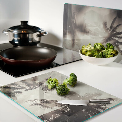 Tagliere in vetro temperato con motivo di palme su sfondo monocromatico