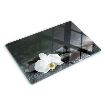 Tagliere in vetro temperato Fiore di orchidea sulle pietre