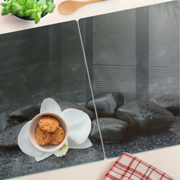 Tagliere in vetro temperato con motivo a fiore di orchidea su pietre